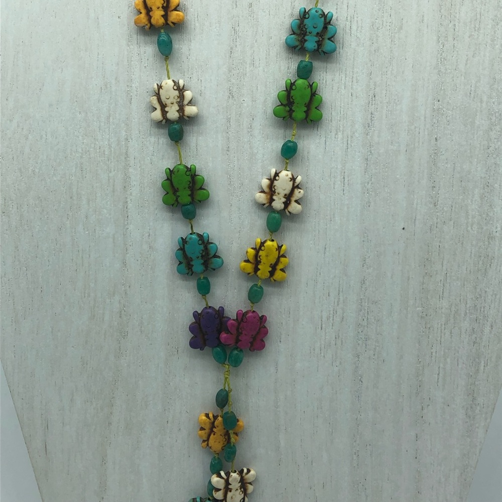 Multi colored bee tassel necklace .